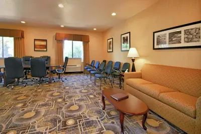 a waiting room with chairs and a couch and tables at Best Western San Dimas Hotel & Suites in San Dimas