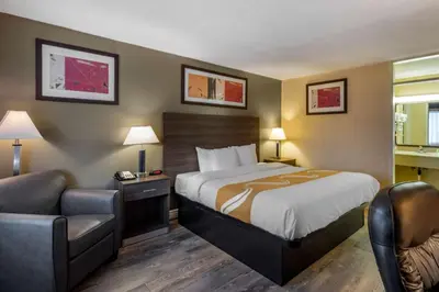 a hotel room with a bed and a couch at Quality Inn Barstow Route 66 in Barstow
