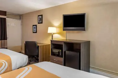 a hotel room with a bed and a flat screen tv at Quality Inn Barstow Route 66 in Barstow