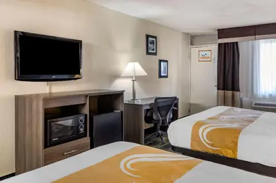 a hotel room with two beds and a flat screen tv at Quality Inn Barstow Route 66 in Barstow