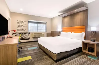 a hotel room with a large bed and a desk at Rodeway Inn near Melrose Ave in Los Angeles