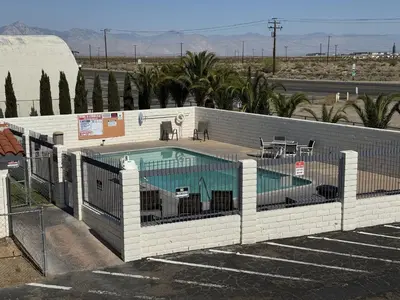 a swimming pool with a fence around it at Days Inn by Wyndham Ridgecrest near China Lake Naval Station in Ridgecrest