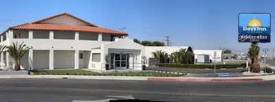 a white building on the corner of a street at Days Inn by Wyndham Ridgecrest near China Lake Naval Station in Ridgecrest