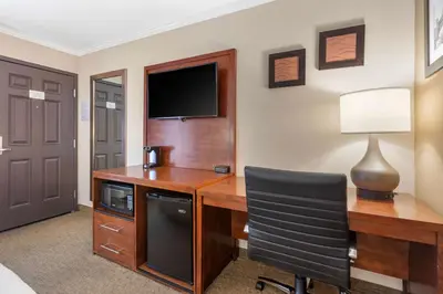 a room with a desk with a television and a chair at Comfort Inn Santa Monica - West Los Angeles in Los Angeles