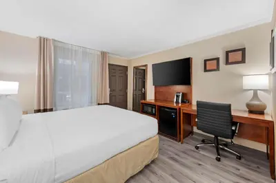 a hotel room with a bed and a desk with a computer at Comfort Inn Santa Monica - West Los Angeles in Los Angeles