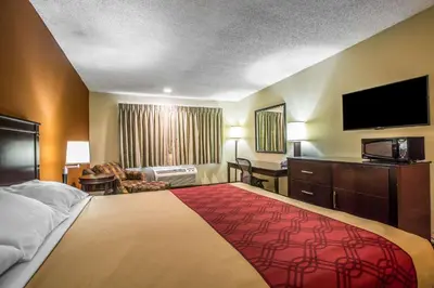 a hotel room with a large bed and a flat screen tv at Baymont by Wyndham Ontario in Ontario