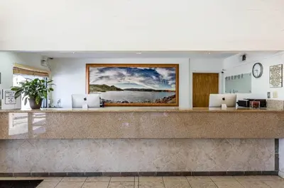 a lobby with two laptops on a counter at Rodeway Inn Magic Mountain Area in Castaic