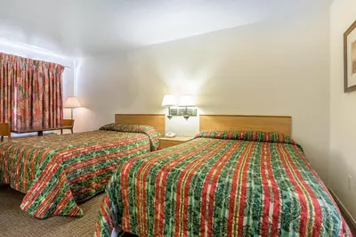 a hotel room with two beds and two lamps at Rodeway Inn Magic Mountain Area in Castaic
