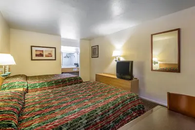 a hotel room with a bed and a television at Rodeway Inn Magic Mountain Area in Castaic