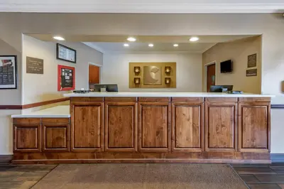 a large bar with wooden cabinets in a room at Comfort Suites Near Six Flags Magic Mountain in Stevenson Ranch