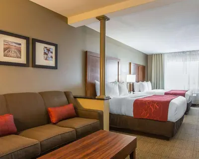 a hotel room with a bed and a couch at Comfort Suites Victorville-Hesperia in Victorville