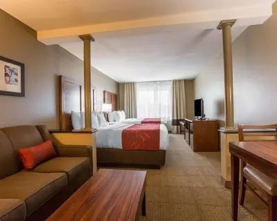 a hotel room with a bed and a couch at Comfort Suites Victorville-Hesperia in Victorville