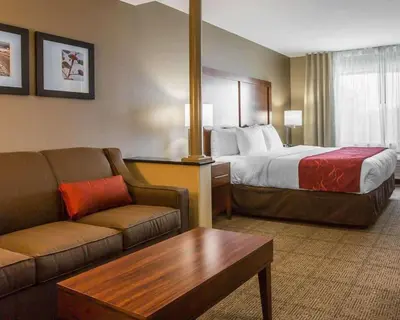 a hotel room with a bed and a couch at Comfort Suites Victorville-Hesperia in Victorville