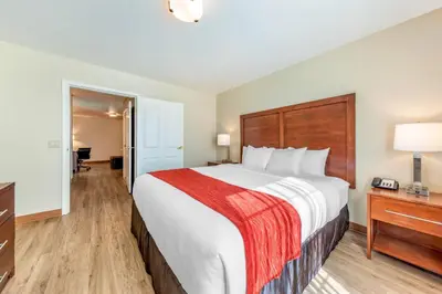 a hotel room with a large bed and a desk at Comfort Inn & Suites Lancaster Antelope Valley in Lancaster