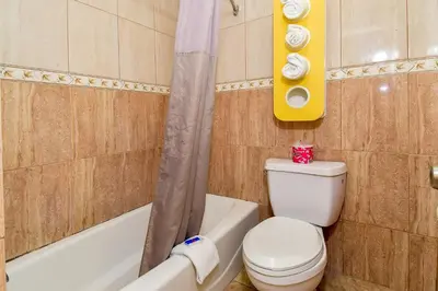a bathroom with a toilet and a tub and a sink at Motel 6 Garden Grove in Anaheim