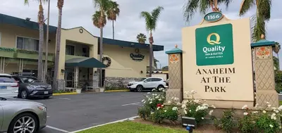 an apartment at the park sign in front of a parking lot at Quality Inn & Suites Anaheim at the Park in Anaheim