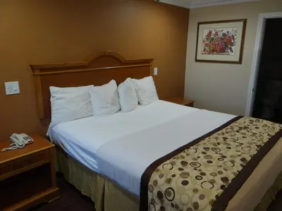 a hotel room with a large bed in a room at Rodeway Inn Cypress - Buena Park in Cypress