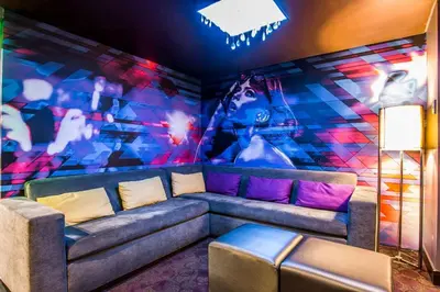a room with a couch and a colorful wall at Tilt Hotel Universal-Hollywood, an AGA Collection Hotel in Los Angeles