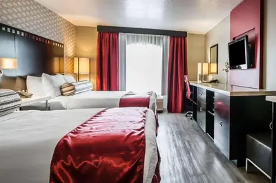 a hotel room with two beds and a television at Tilt Hotel Universal-Hollywood, an AGA Collection Hotel in Los Angeles