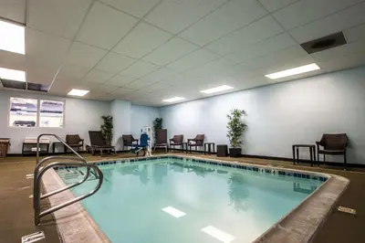 a large swimming pool in a room with chairs at Tilt Hotel Universal-Hollywood, an AGA Collection Hotel in Los Angeles
