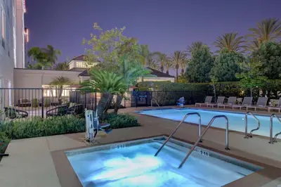 a swimming pool with a hot tub at Hilton Garden Inn Anaheim/Garden Grove in Anaheim