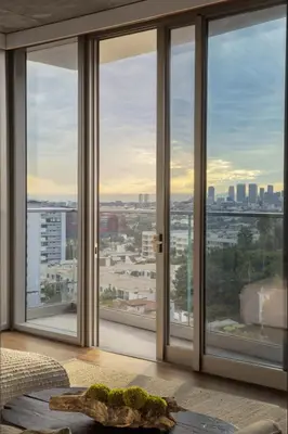 a room with large windows with a view of a city at 1 Hotel West Hollywood in Los Angeles