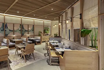 a restaurant with tables and chairs in a room at 1 Hotel West Hollywood in Los Angeles