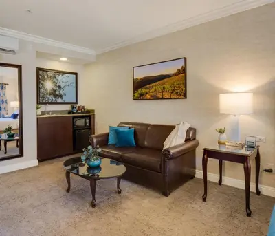 a living room with a couch and a table at Ayres Suites Diamond Bar in Diamond Bar