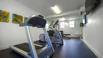 a room with a gym with a treadmill at Vagabond Inn Bakersfield South in Bakersfield