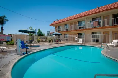 a large swimming pool in front of a hotel at Vagabond Inn Bakersfield South in Bakersfield