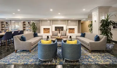 a living room with couches and a table at Ayres Suites Yorba Linda/Anaheim Hills in Anaheim