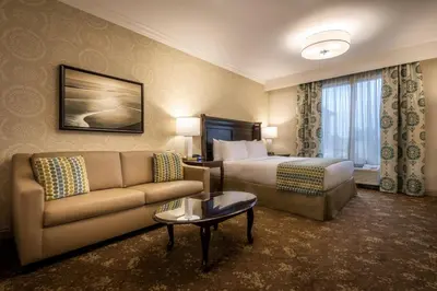 a hotel room with a bed and a couch at Ayres Hotel Seal Beach - Cypress in Seal Beach