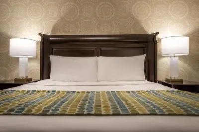 a bedroom with a bed with two lamps on both sides at Ayres Hotel Seal Beach - Cypress in Seal Beach