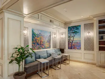 a living room with a couch and a painting at Ayres Hotel Seal Beach - Cypress in Seal Beach