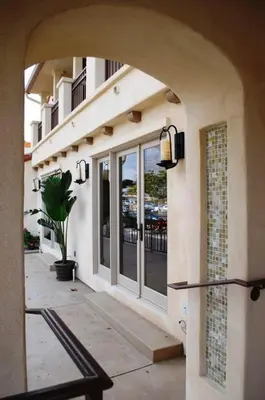 an archway leading to a building with a potted plant at Bella Capri Inn and Suites in Camarillo
