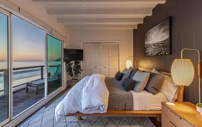 a bedroom with a bed with a view of the ocean at Malibu Beach Home Private Sandy Beach and Surf in Malibu