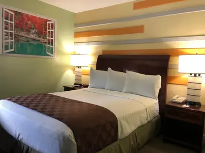 a hotel room with a large bed with two lamps at Knights Inn Los Angeles Central / Convention Center Area in Los Angeles
