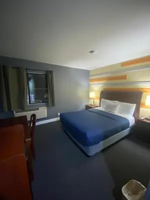 a bedroom with a blue bed and a window at Knights Inn Los Angeles Central / Convention Center Area in Los Angeles