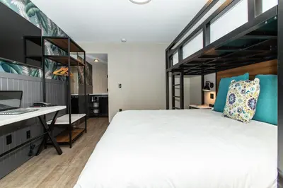 a bedroom with a bed and a desk with a computer at Magnolia Tree Hotel-Maingate/Anaheim Convention Center in Anaheim