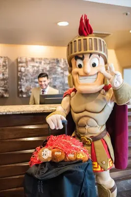 a stuffed toy of goofy standing in front of a counter at USC Hotel in Los Angeles
