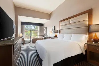 a hotel room with a bed and a television at USC Hotel in Los Angeles
