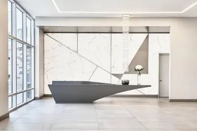a bathroom with a large tub in a room with windows at AC Hotel by Marriott Los Angeles South Bay in Los Angeles