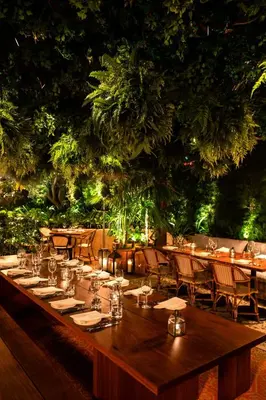 a long table in a restaurant with tables and chairs at The West Hollywood EDITION in Los Angeles