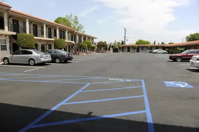 an empty parking lot with cars parked in it at Best Budget Inn Anaheim in Anaheim