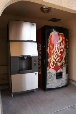 a vending machine with a cocacola coke and a coke refrigerator at Best Budget Inn Anaheim in Anaheim