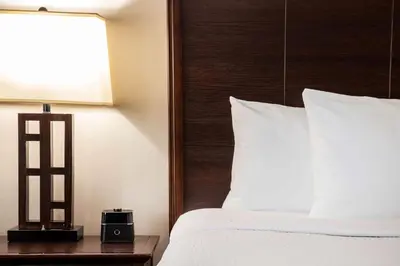 a bedroom with a bed and a clock on a table at La Quinta by Wyndham Inglewood in Inglewood