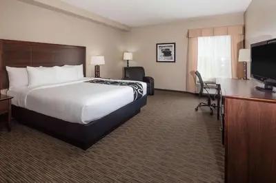 a hotel room with a bed and a flat screen tv at La Quinta by Wyndham Inglewood in Inglewood