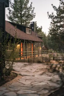 a log cabin with a porch and a stone driveway at Noon Lodge in Big Bear Lake