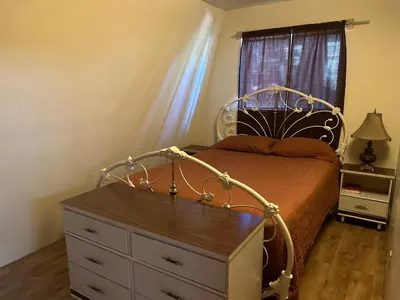 a bedroom with a bed with a dresser and a window at Sequoia National Forest CabinK in Panorama Heights