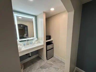 a bathroom with a sink and a mirror at Economy Inn - Burbank Airport in Sun Valley